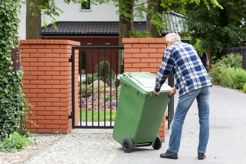 Workers loading bulky items from an office space for rubbish disposal