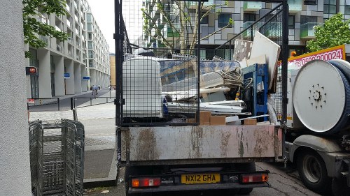Man and van team carrying furniture from a multi-storey flat